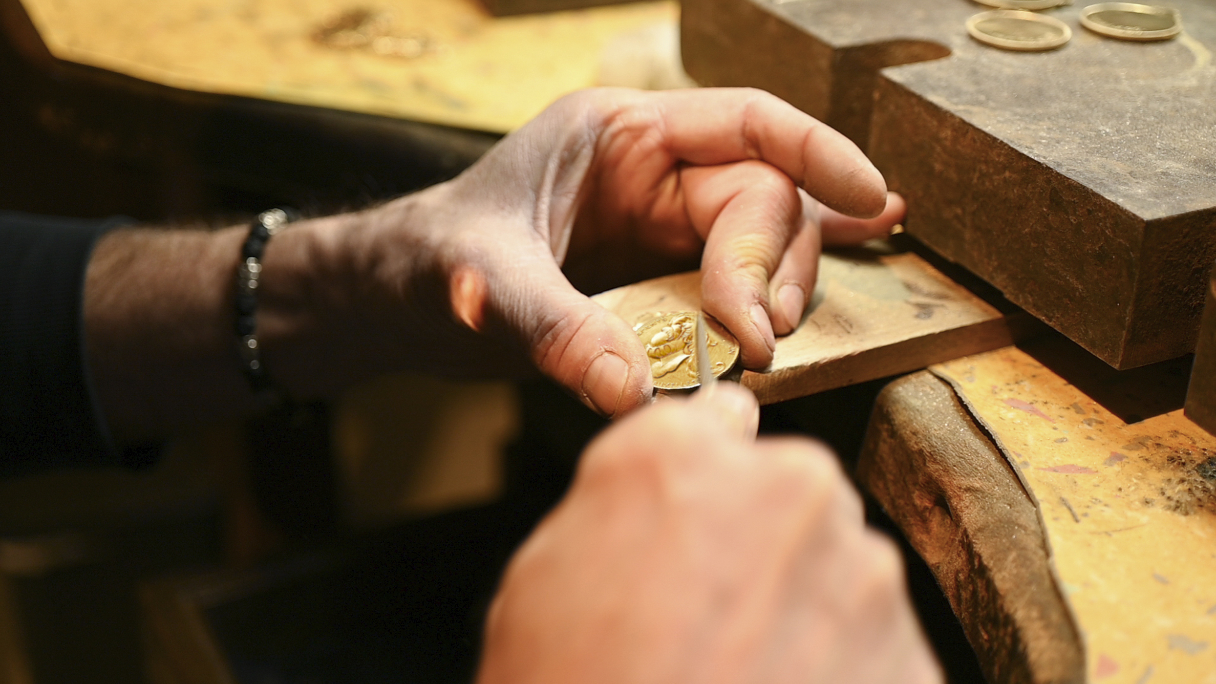 Artist finishing collector coin